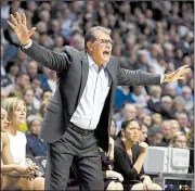  ?? AP/JESSICA HILL ?? Connecticu­t Coach Geno Auriemma calls out to his players during the No. 1 Huskies’ victory over Oklahoma on Tuesday night. It was Auriemma’s 1,000th career victory.