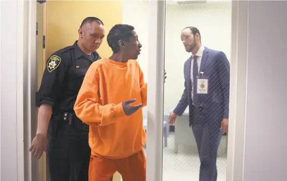  ?? Liz Hafalia / The Chronicle ?? An inmate named D.J. leaves the interview room after speaking with Deputy Public Defender Chesa Boudin (right) as part of the Pretrial Release Unit’s efforts.