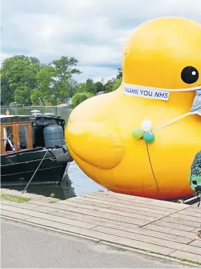  ?? Picture: Geoffrey Swaine/ Shuttersto­ck. ?? The Macmillan Cancer Support big yellow duck is raising money for the charity along the banks of the River Thames. The duck, in keeping with the times, was wearing a face mask in Henley-on-Thames yesterday.