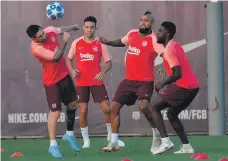  ?? AFP ?? Lionel Messi, left, training with his Barcelona teammates ahead of their Champions League tie with PSV Eindhoven