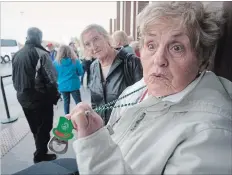  ?? JASON BAIN EXAMINER ?? Peterborou­gh’s Lois Phillip, first in line to enter Shorelines Casino Peterborou­gh, holds up her lucky bottle opener as she spoke with Examiner reporter Joelle Kovach a few hours before the Crawford Drive casino opened.