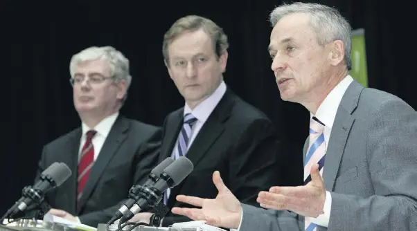  ??  ?? A BIT TIED UP: Eamon Gilmore, Enda Kenny and Richard Bruton at the Action Plan for Jobs press conference last Monday