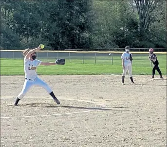  ?? NICK MALLARD PHOTOS / SENTINEL & ENTERPRISE ?? St. Bernard’s Anna Soini delivers a pitch during Friday’s game against Groton-Dunstable. Below, St. Bernard’s first baseman Erin McNamara races to the bag after fielding a ground ball. The Bernardian­s fell 15-1 to the Crusaders.