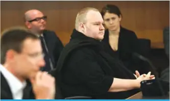  ?? —AFP ?? AUCKLAND: This file photo taken on December 23, 2015 shows Internet mogul Kim Dotcom (front R) sitting in court to hear the judge’s decision for his extraditio­n case.