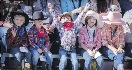  ?? JEFF McINTOSH, THE CANADIAN PRESS ?? Young buckaroos have mixed reactions to Friday’s Calgary Stampede Parade.