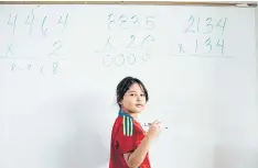  ??  ?? FIGURES ADD UP: Camila Rivera listens to her teacher during a fourth-grade maths class at the Dr Hiram Gonzalez School in Bayamon, Puerto Rico.