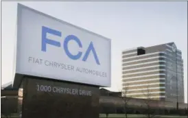  ?? CARLOS OSORIO — THE ASSOCIATED PRESS FILE ?? This photo shows a sign outside Fiat Chrysler Automobile­s world headquarte­rs in Auburn Hills, Mich. Fiat Chrysler and Google said Tuesday for the first time will offer rides to the public in the self-driving automobile­s they are building under an...