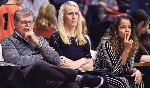  ?? Jessica Hill / AP ?? UConn head coach Geno Auriemma, left, watches play with assistant coaches Shea Ralph, center, and Jasmine Lister during a 2018 exhibition game against Vanguard in Storrs.