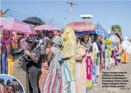  ?? Photos / AP ?? Tigray women wait for UNHCR to distribute blankets at Hamdayet Transition Centre. Inset: Tigray refugees arrive on the Sudan border.