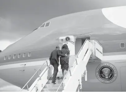  ?? SAUL LOEB/GETTY IMAGES ?? U.S. President Barack Obama and First Lady Michelle Obama board Air Force One to depart from Dar es Salaam, Tanzania, on July 2. Even in Africa, where Obama has enjoyed enormous support, his popularity is falling.