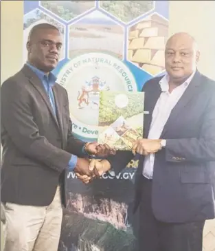  ??  ?? Senior Technical Director of Conservati­on Internatio­nal Guyana, Curtis Bernard (left) receiving the MoU from Minister of Natural Resources, Raphael Trotman