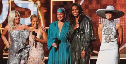  ?? REUTERS PIC ?? (From left) Lady Gaga, Jada Pinkett Smith, Alicia Keys, Michelle Obama and Jennifer Lopez speaking on stage at the Grammys in Los Angeles on Sunday.