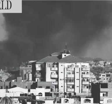  ?? THOMAS COEX / AFP / GETTY IMAGES ?? Smoke billows over Gaza City on Tuesday following an Israeli airstrike on the Palestinia­n coastal enclave.