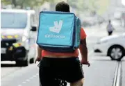  ?? /Reuters ?? More protection: A delivery worker with a backpack of Deliveroo rides a bike in Nice, France.