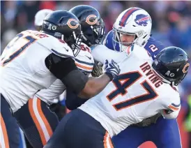  ?? ADRIAN KRAUS/AP ?? Bears linebacker Isaiah Irving brings down Bills quarterbac­k Nathan Peterman, who was picked off three times, in the second half Sunday at New Era Field.