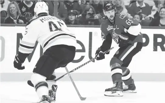  ?? JEAN LEVAC ?? Senators defenceman Erik Karlsson looks up the ice while being watched by the Bruins’ Joe Morrow in Game 5. Karlsson was named a finalist for the Norris Trophy on Friday.