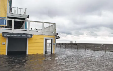  ?? JOSE LUIS MAGANA/GETTY-AFP ?? Dorian’s storm surge floods a shop Friday in Cape Hatteras, North Carolina, where the Category 1 hurricane made landfall.