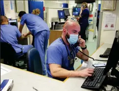  ??  ?? Safety: Staff in the emergency department wear PPE whether dealing with patients or paperwork