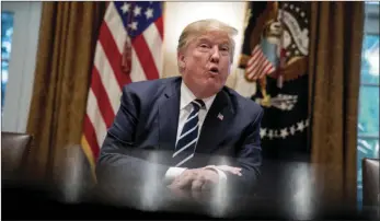  ??  ?? President Donald Trump speaks to members of the media as he meets with members of Congress in the Cabinet Room of the White House, on Tuesday in Washington. AP PHOTO/ANDREW HARNIK