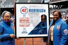  ?? ASSOCIATED PRESS ?? RACHEL ROBINSON , left, widow of Jackie Robinson, and daughter Sharon pose for a photograph with a plaque honoring Jackie on Jackie Robinson Day, Sunday in New York, before a baseball game between the New York Mets and the Milwaukee Brewers.
Indiana...