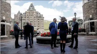  ?? CP PHOTO JEFF MCINTOSH ?? Attendees enjoy an outdoor break at the Global Business Forum in Banff on Thursday.