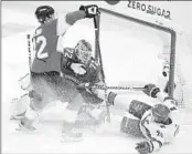  ?? WILFREDO LEE AP ?? Hurricanes center Sebastian Aho (20) goes down as he attempts a shot at goaltender Sergei Bobrovsky.