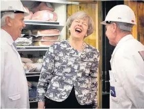  ??  ?? > Prime Minister Theresa May on a visit to Smithfield Market in the City of London on the final day of campaignin­g yesterday