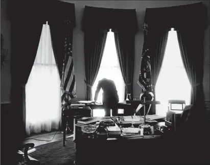  ?? COURTESY THE JACQUES LOWE ESTATE ?? John and Jacqueline Kennedy were newly married when they sat for this photo booth portrait in 1953. Seen in the Oval Office in January 1961, Kennedy would often stand over his desk because of his bad back.