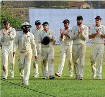  ?? GETTY IMAGES ?? The Black Caps clap off team-mate Ajaz Patel, second from left, after he took a five-wicket haul against Sri Lanka in Galle.