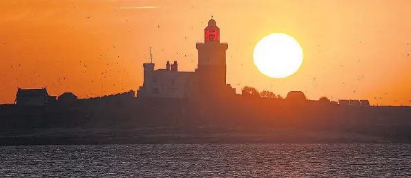  ?? Picture: PAUL KINGSTON/NNP ?? A glorious sunrise fills the eastern horizon at Coquet Island, a bird sanctuary in Northumber­land, where temperatur­es are expected to soar later this week