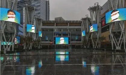  ??  ?? Video screens show images of LA Lakers star Anthony Davis in a plaza across from Staples Center in March. Photograph: Damian Dovarganes/AP