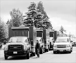  ?? REBEKAH WELCH
THE ASSOCIATED PRESS ?? Washington State Department of Natural Resources trucks wait to board a ferry to Ketron Island, Saturday, Aug. 11, where a stolen commercial plane crashed.