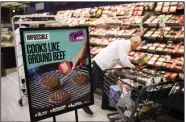  ?? (Bloomberg News/Patrick T. Fallon) ?? An aisle sports an Impossible Foods sign during the introducti­on of the product at a Los Angeles grocery store in September.