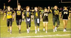  ?? MARK HUMPHREY ENTERPRISE-LEADER ?? Prairie Grove senior football players and cheerleade­rs joined hands for a senior walk Friday, celebratin­g the last home game of the regular season, a 49-6 thrashing of Berryville, which wrapped up the 4A-1 Conference title and home-field advantage...