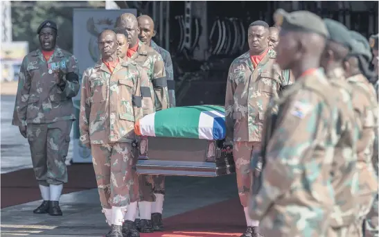 ?? Picture: AFP ?? ON HOME GROUND. Members of the SANDF carry a flag-draped coffin during the return of the remains of Captain Simon Mkhulu Bobe and Lance Corporal Irven Thabang Semono at Air Force Base Waterkloof on Wednesday. They were killed in a mortar strike at a SANDF base in Sake, Democratic Republic of Congo, on 14 February.