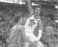  ?? RICK BOWMER/AP ?? Jazz center Hassan Whiteside (21) celebrates after dunking against Thunder forward Jeremiah Robinson-Earl (50) during the second half Wednesday in Salt Lake City.