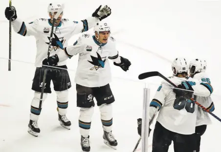  ?? Mark Humphrey / Associated Press ?? The Sharks’ Brent Burns (88) celebrates with teammates after scoring with 2:52 remaining to cap a rally that beat the Predators.