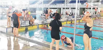  ??  ?? Members of the Sarawak women’s team do their warming up and training at the Sarawak Aquatic Centre yesterday.