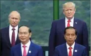  ?? HAU DINH — THE ASSOCIATED PRESS FILE ?? Back left to right; Russian President Vladimir Putin, and U.S. President Donald Trump, front row left to right; Vietnamese President Tran Dai Quang, and Indonesian President Joko Widodo pose for a photo during the family photo session during the...