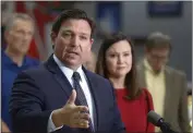  ?? CALVIN KNIGHT — THE LEDGER VIA AP ?? Florida Gov. Ron DeSantis flanked by Attorney General Ashley Moody and supporters addresses the media and supporters Thursday in Lakeland Fla.