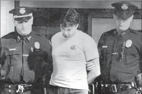  ?? AP FILE PHOTO ?? Peter Dushame, 33, of North Andover, Mass., center, is lead out of Nashua District Court in Nashua, N.H., on Oct. 3, 1989, after his arraignmen­t on a negligent homicide charge.