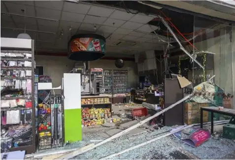  ??  ?? Debris are scattered on the floor of a damaged store a day after a strong quake struck in Digos, Davao del Sur province, southern Philippine­s Thursday, Oct. 17, 2019. A powerful and shallow earthquake hit several southern Philippine provinces Wednesday night injuring some people in collapsed houses and prompting thousands to scramble out of homes, shopping malls and a hospital in panic, officials and news reports said. (AP Photo)