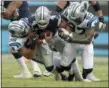  ?? MIKE MCCARN — ASSOCIATED PRESS ?? Cowboys’ Dak Prescott is tackled by Carolina Panthers’ Wes Horton, left, and Mario Addison during the second half of Sunday’s game in Charlotte, N.C.