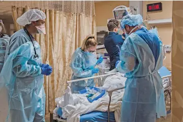  ?? (AFP) ?? Healthcare workers tend to a COVID-19 patient at Providence St Mary Medical Center in Apple Valley, California on Monday