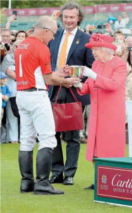  ?? ?? The Queen and Laurent Feniou, managing director of Cartier UK, presenting the Cartier Queen's Cup to David Paradice of the Scone Polo Team in June 2019. Image courtesy of Images of Polo.