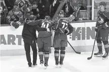  ?? Andy Cross, The Denver Post ?? Avalanche center Pierre-Edouard Bellemare in helped off the ice after an apparent knee injury in the first period on Thursday night at Ball Arena.