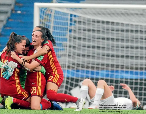  ?? AP ?? Spanish players celebrate while two New Zealanders show their despair at the end of the semifinal, won 2-0 by Spain.