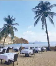  ??  ?? Setup for dinner on the beach with live music provided by Apulit’s talented singing chef