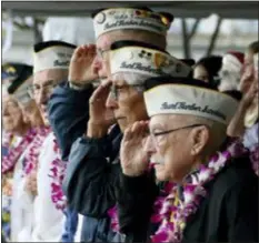  ?? AUDREY MCAVOY - THE ASSOCIATED PRESS ?? Pearl Harbor survivors salute during the National Anthem at a ceremony in Pearl Harbor, Hawaii on Friday marking the 77th anniversar­y of the Japanese attack.
