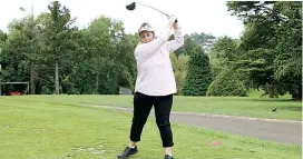  ??  ?? Left - President of the Warragul women’s golf, Wilma Henshall, tees off during competitio­n in what were trying conditions last week.